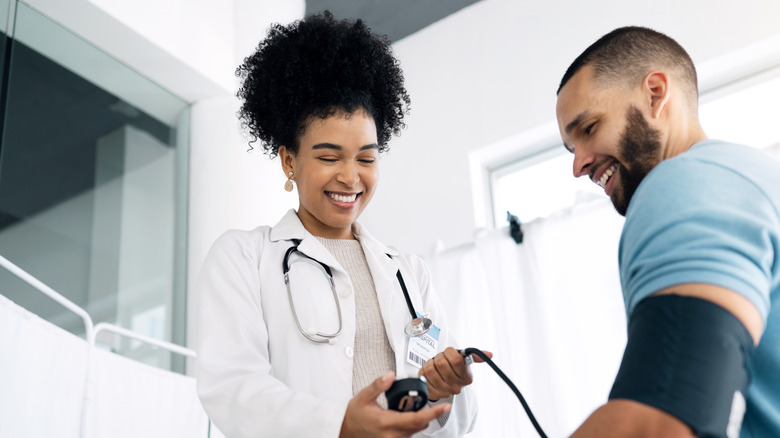 nurse checking man's blood pressure