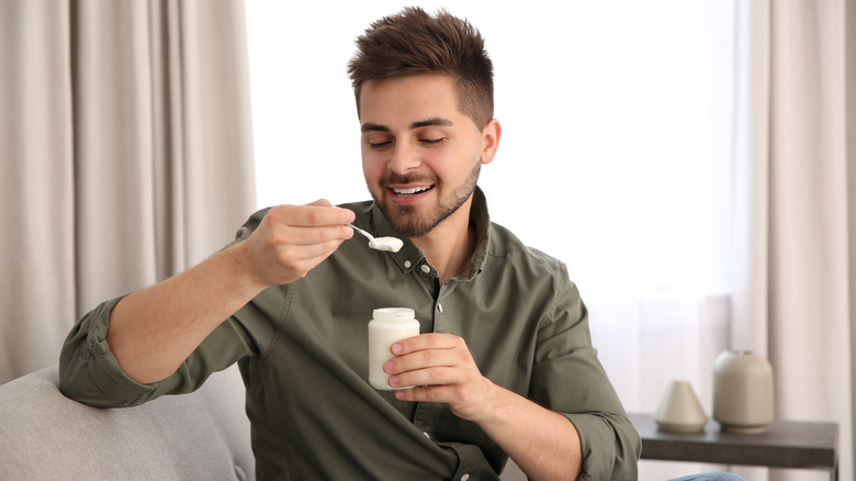 Man eating scoop of yogurt