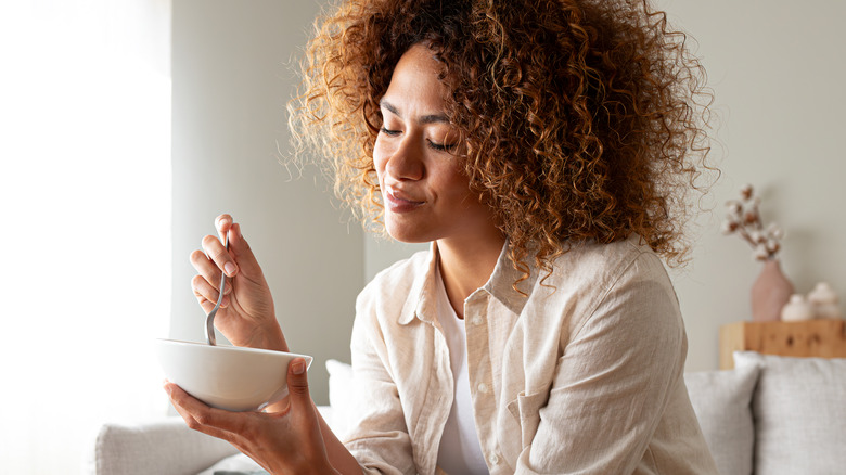 Woman eating out of bowl