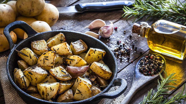 pan of roasted potatoes with garlic, olive oil, and rosemary