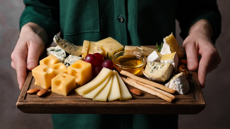 person holding a charcuterie board