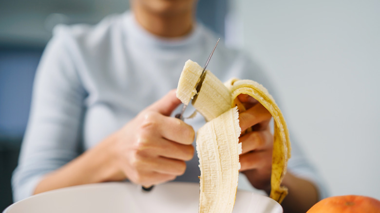 Woman eating banana