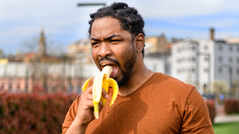 Man eating banana