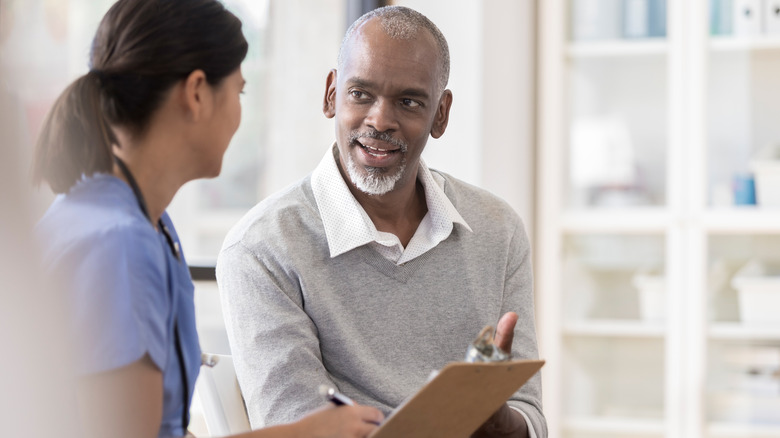 Man speaking to doctor