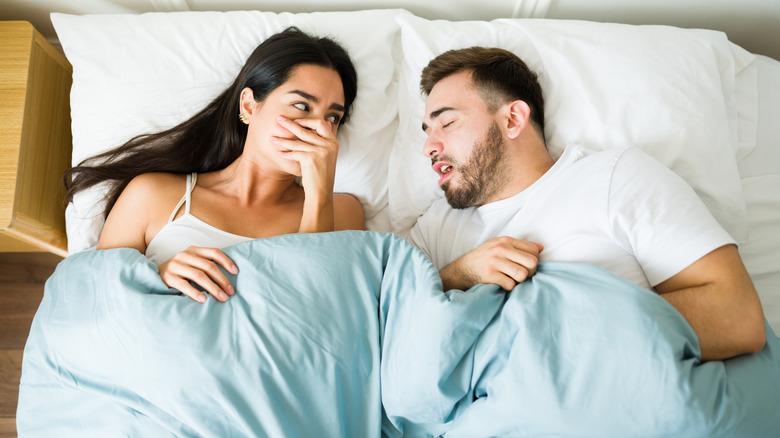 Woman covering her nose from stinky smell