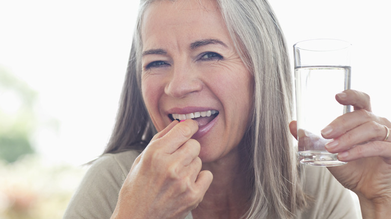 woman taking a pill