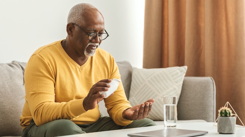 Older man taking pills