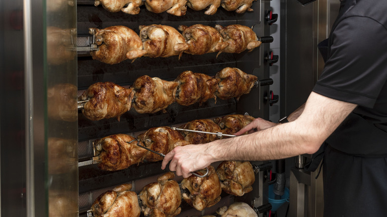 a row of rotisserie chickens