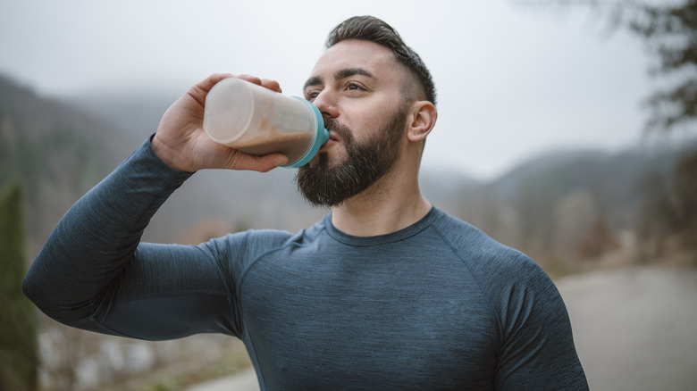 Athletic man drinking protein shake