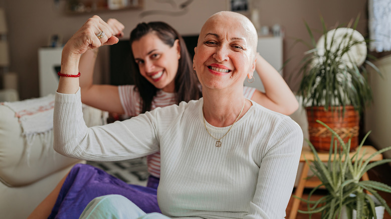 mother and daughter displaying arm muscles