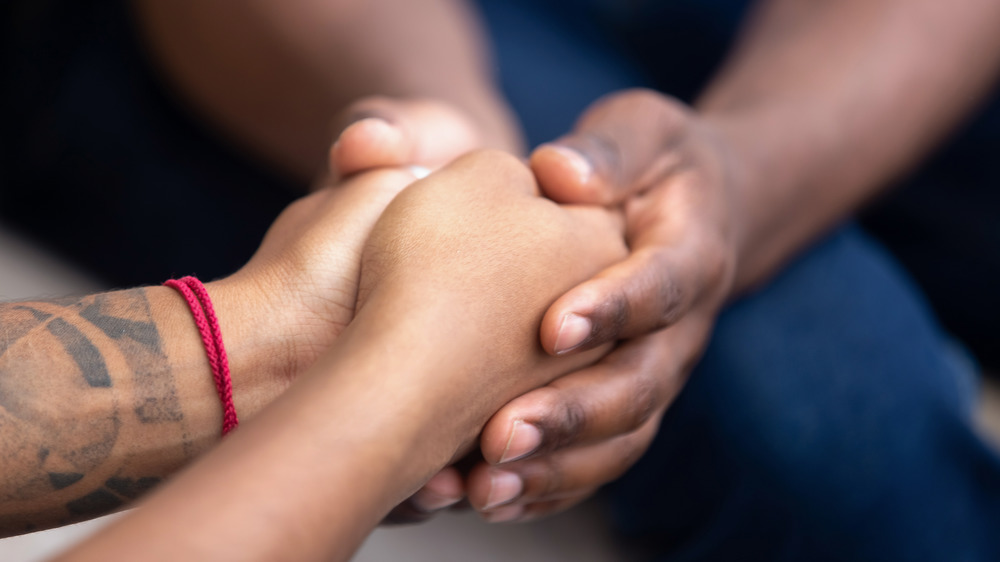 Couple holding hands