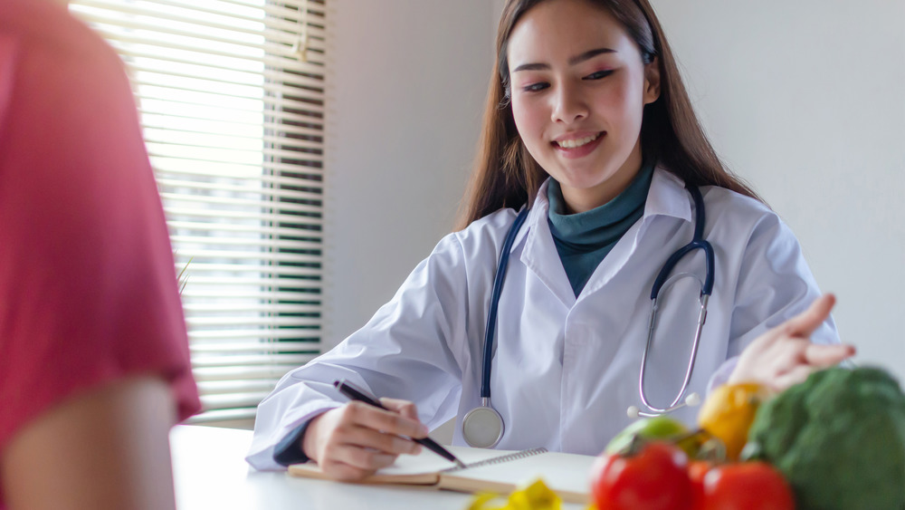 Health care professional giving nutrition advice at a desk
