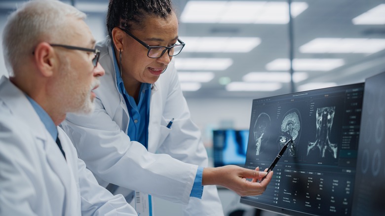 doctors looking at MRI of patient