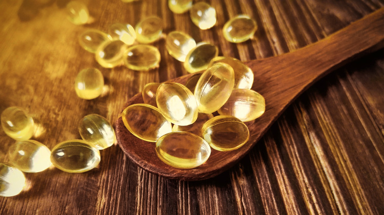 Vitamin E capsules on spoon