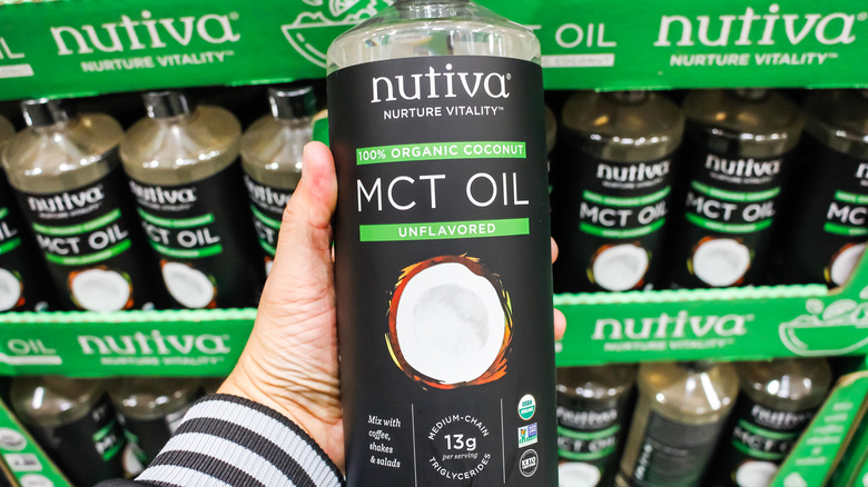 holding bottle of MCT oil