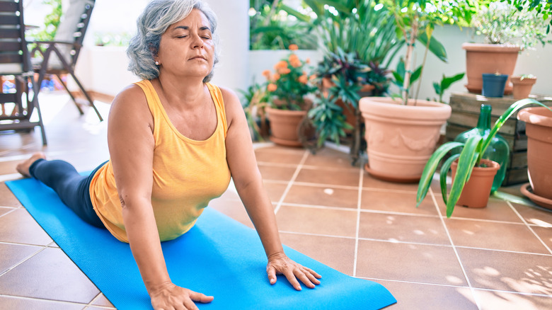 woman practicing yoga on a mat