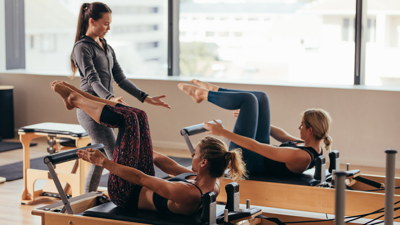 Women in a Pilates class using specialized machines