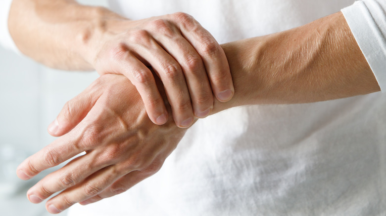 Man with arthritis pain in hand and wrist