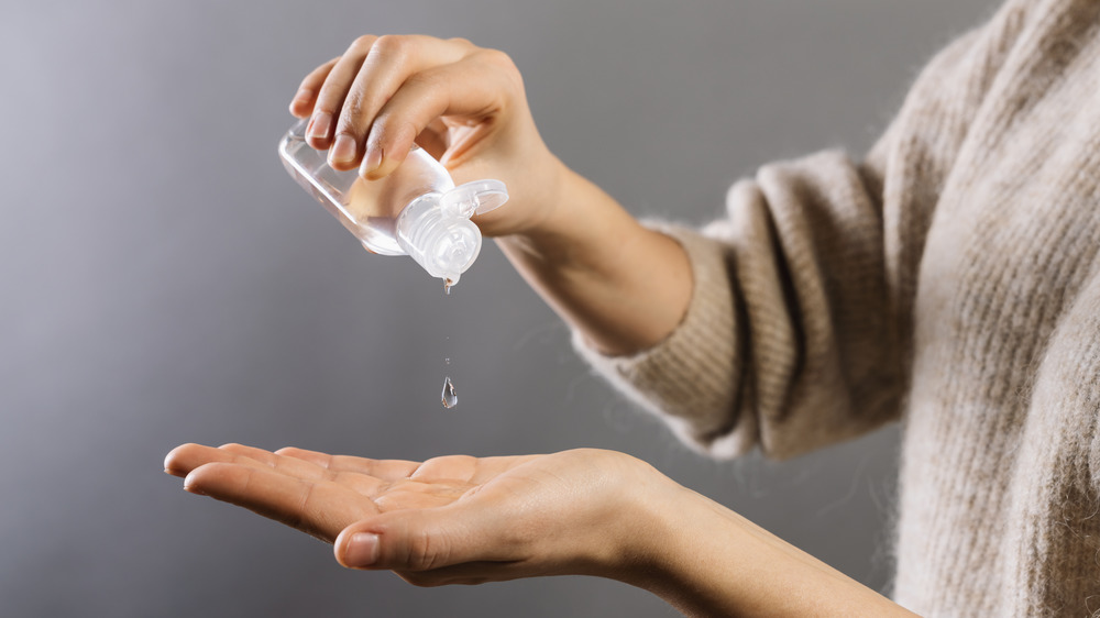 Woman using hand sanitizer 