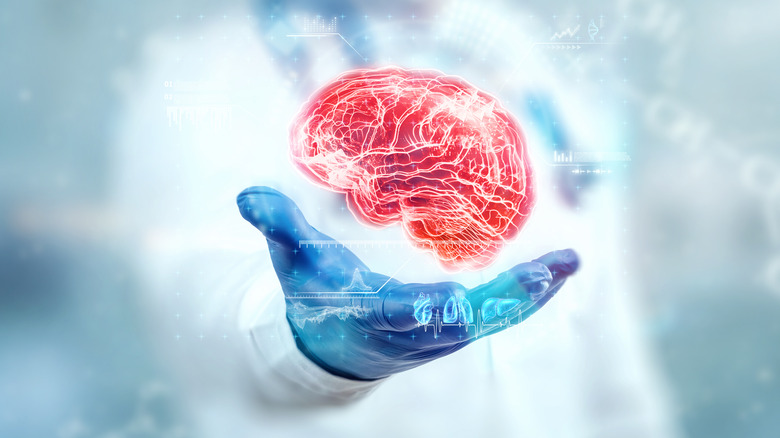 Image of brain hovering above hand