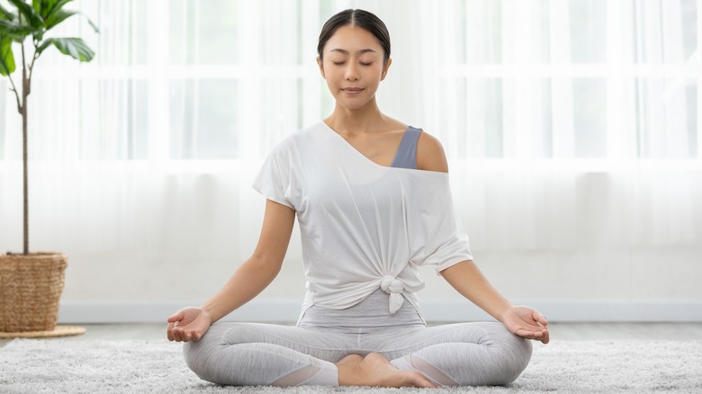 Woman sitting cross-legged in meditation