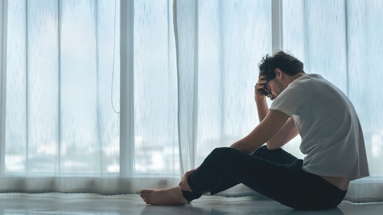 Sad man sitting in room 