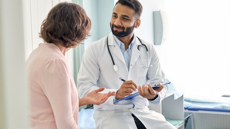 Doctor consulting woman in office