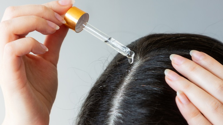 woman using pipette hair
