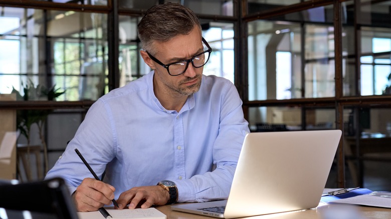 Man researching anxiety on laptop