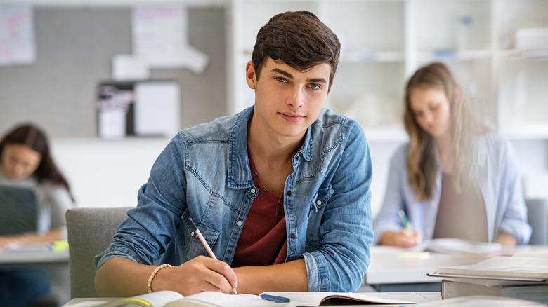 Young man at desk in class