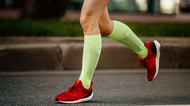 a runner wearing light green compression socks 