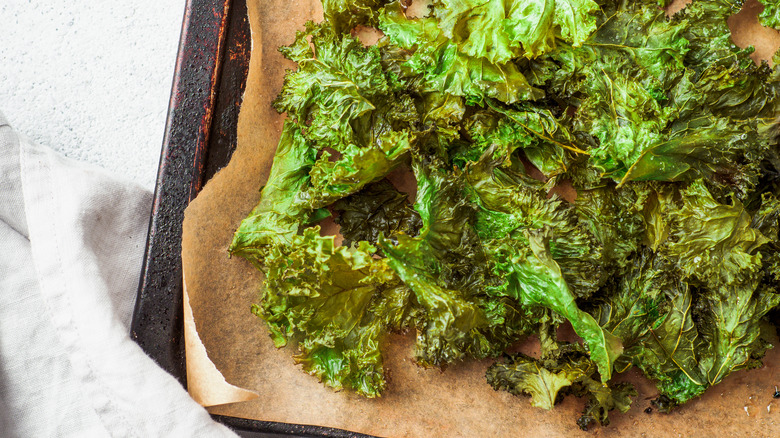 Roasted kale chips on a cookie sheet
