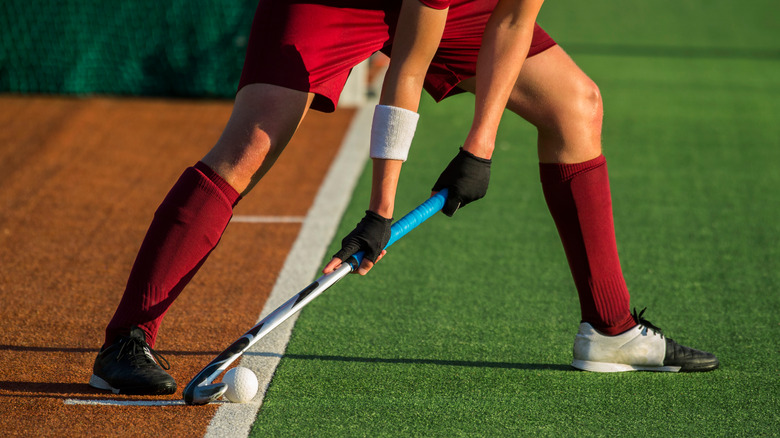 Close up of a field hockey player's stick midplay