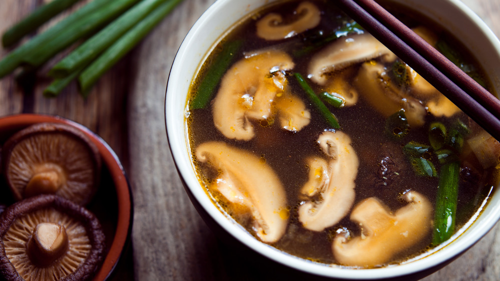 A bowl of soup with shiitake mushrooms 