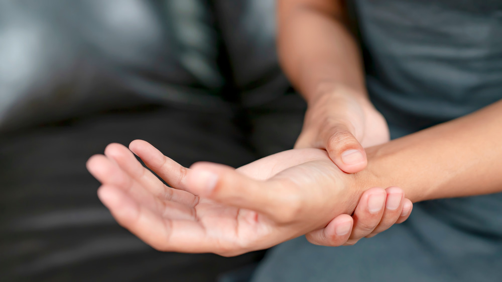 Right hand holding the wrist of other upturned hand