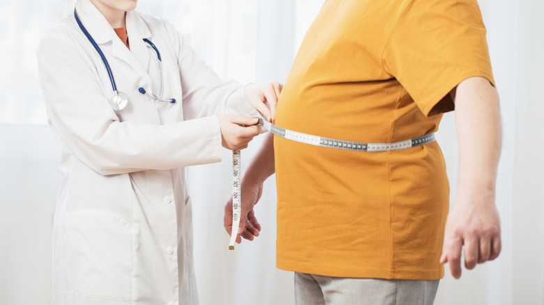 doctor measuring a patient's stomach