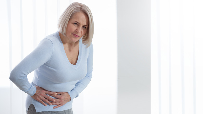 Woman holding her stomach in pain