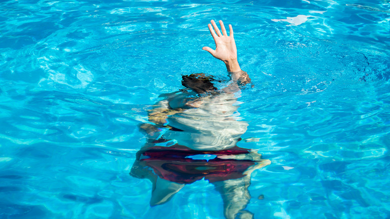 A man sinking into a pool