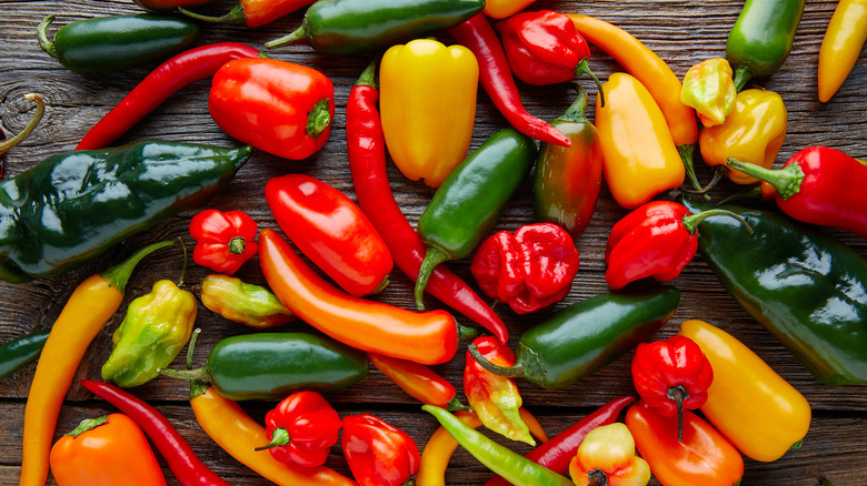 Assortment of peppers on wooden table