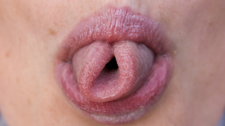 A woman rolling her tongue