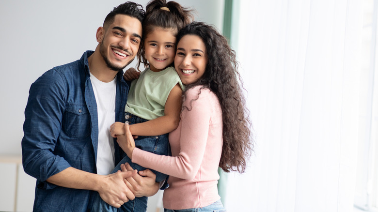 Happy couple with young daughter