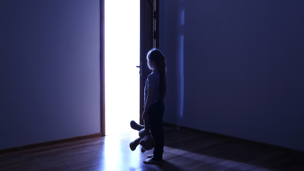 Young girl standing in doorway