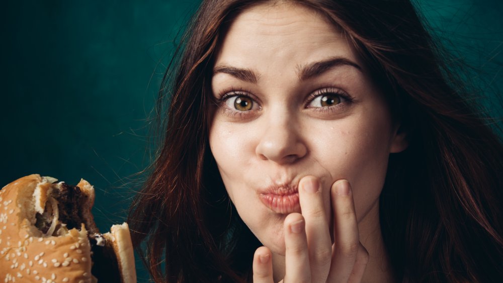 Woman eating hamburger