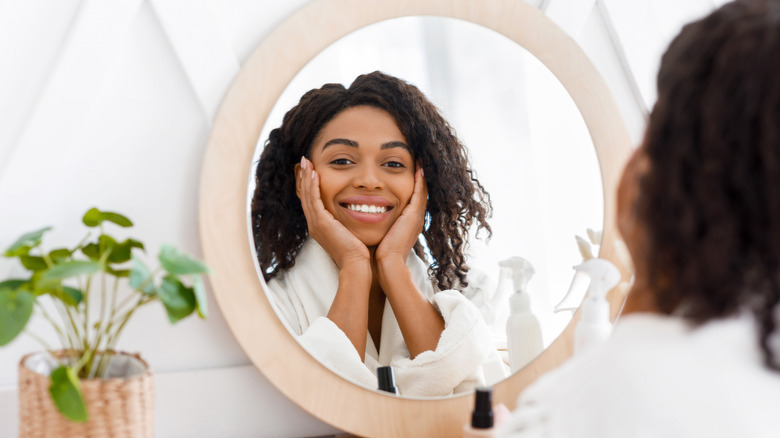 A woman smiling in the mirror