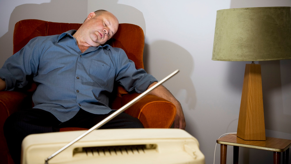 Man sleeping in front of TV