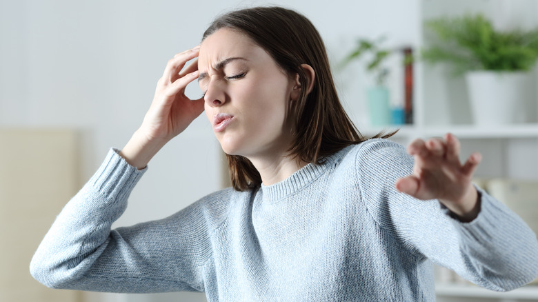 Woman feeling dizzy at home