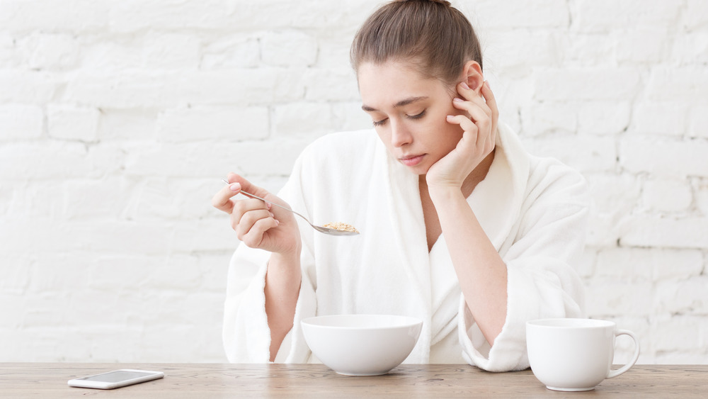 woman bored while eating