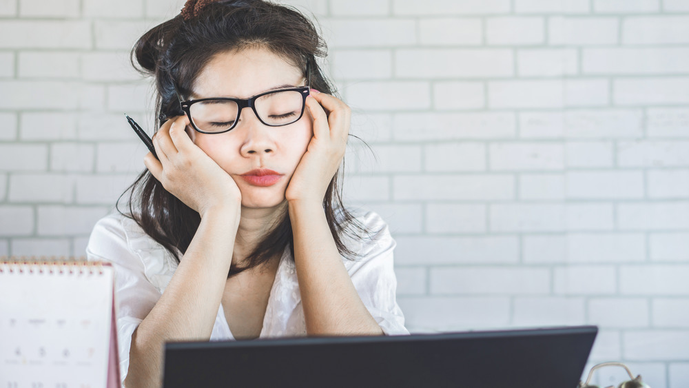 tired woman at desk