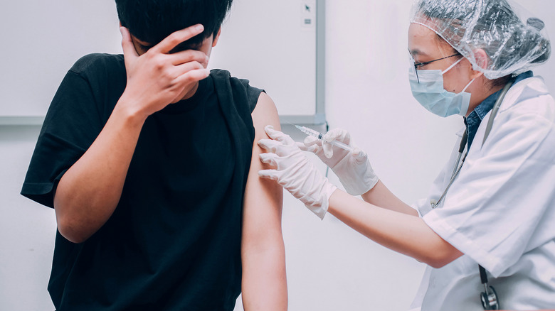 scared patient receiving injection