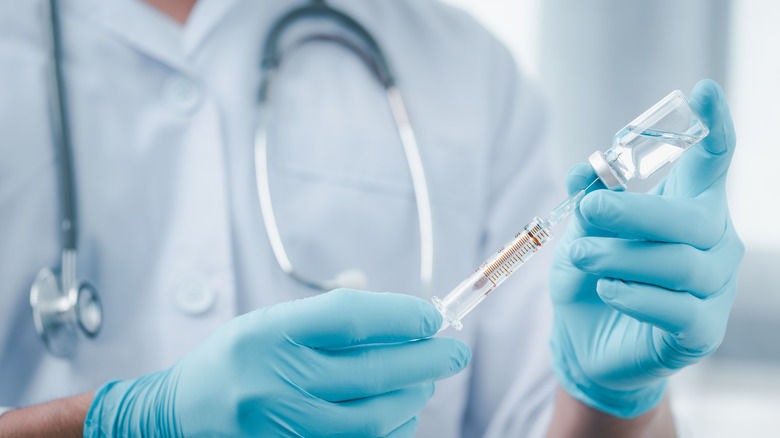 doctor holding syringe